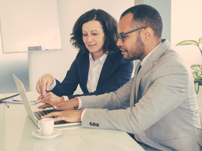 Real estate investors discussing a buy-and-hold investing strategy.