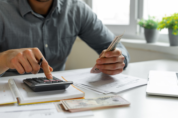 A man counting money decides whether a Coverdell ESA is right for his family