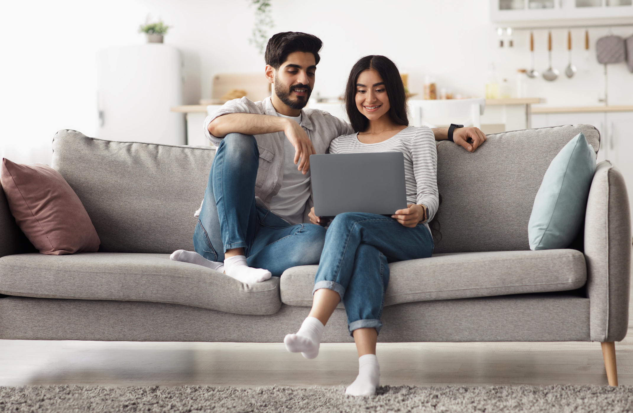 A couple researching the benefits and drawbacks of a rent-to-own arrangement.