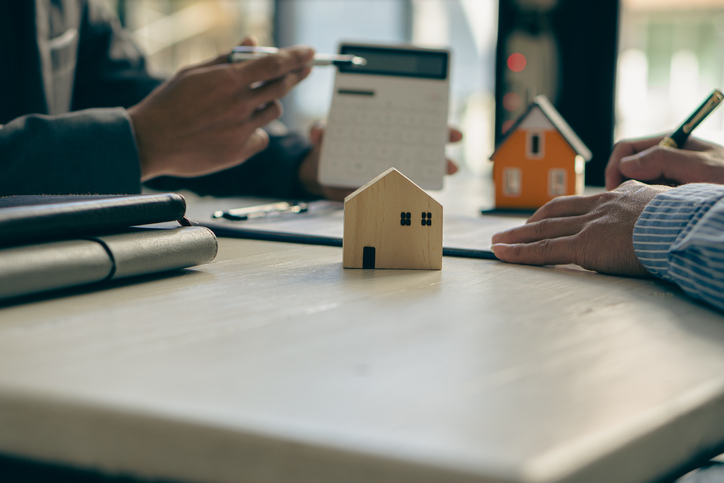 An investor meeting with a financial advisor to discuss a real estate investment.