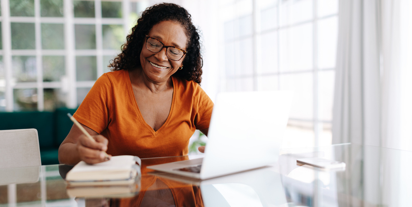 A woman reviews her investment portfolio, having used the compounded interest formula to create her investment plan.