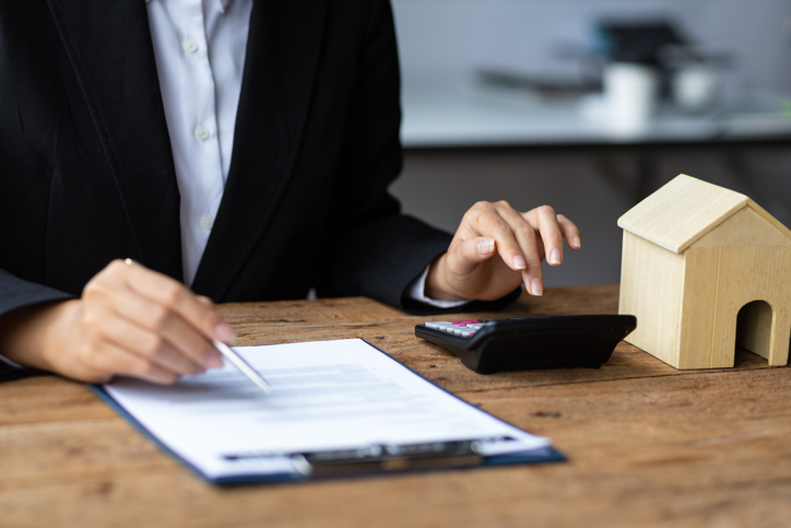 An investor calculating how much she could earn on a real estate investment.